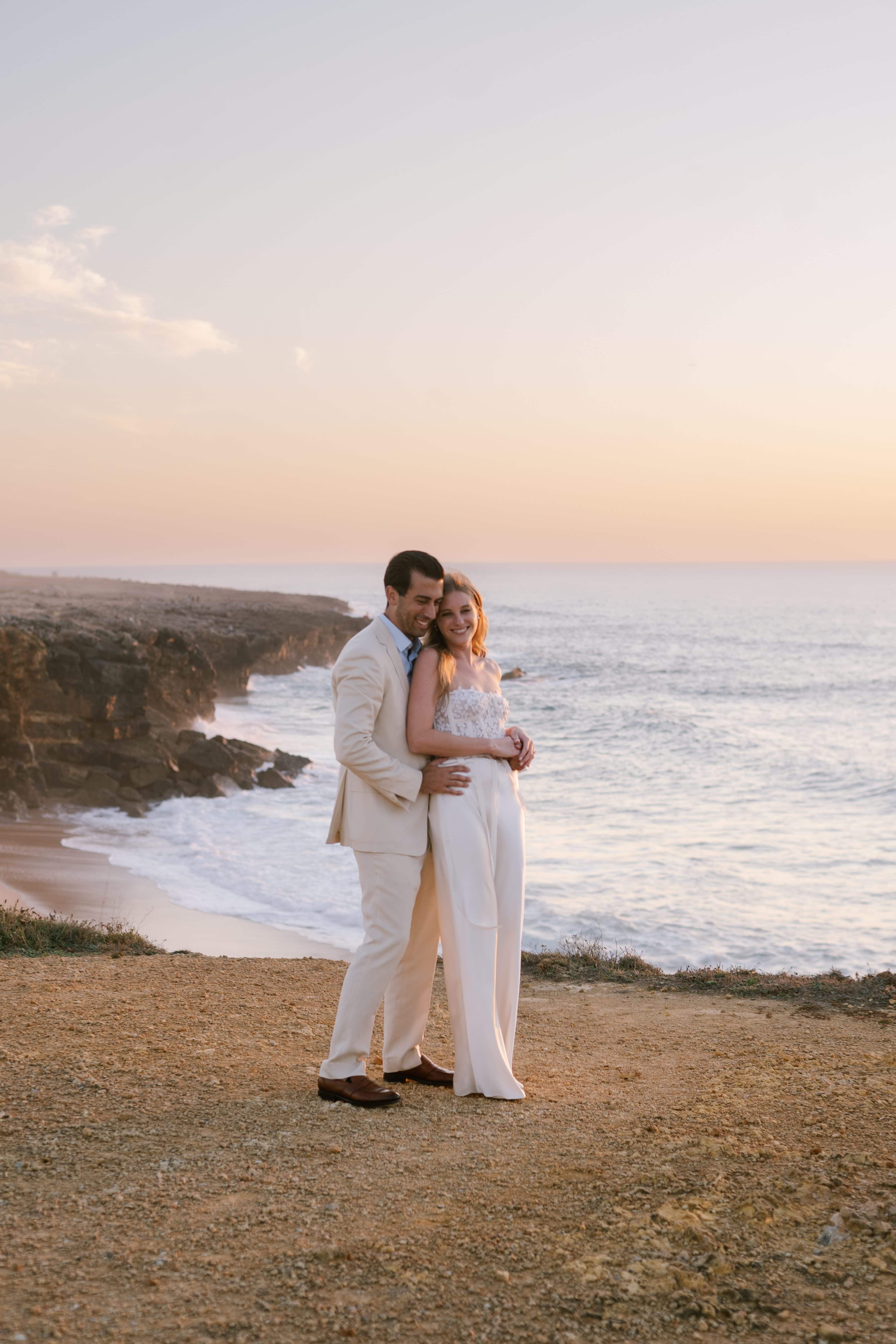 Couple embracing on the cliffs at sunset