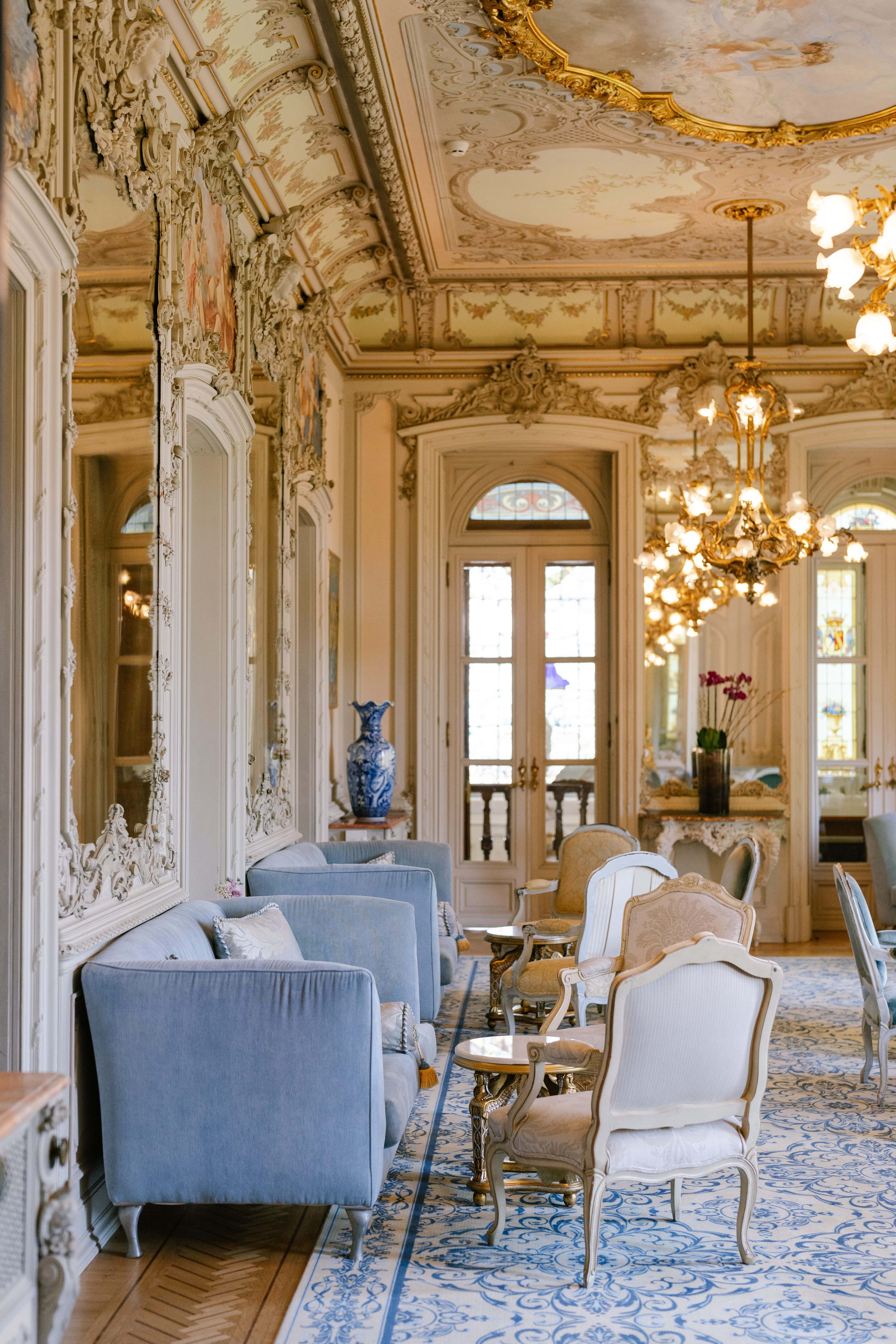 Lounge with antique furniture and a blue rug inside Pestana Palace, Lisbon Lounge with antique furniture and a blue rug inside Pestana Palace, Lisbon
