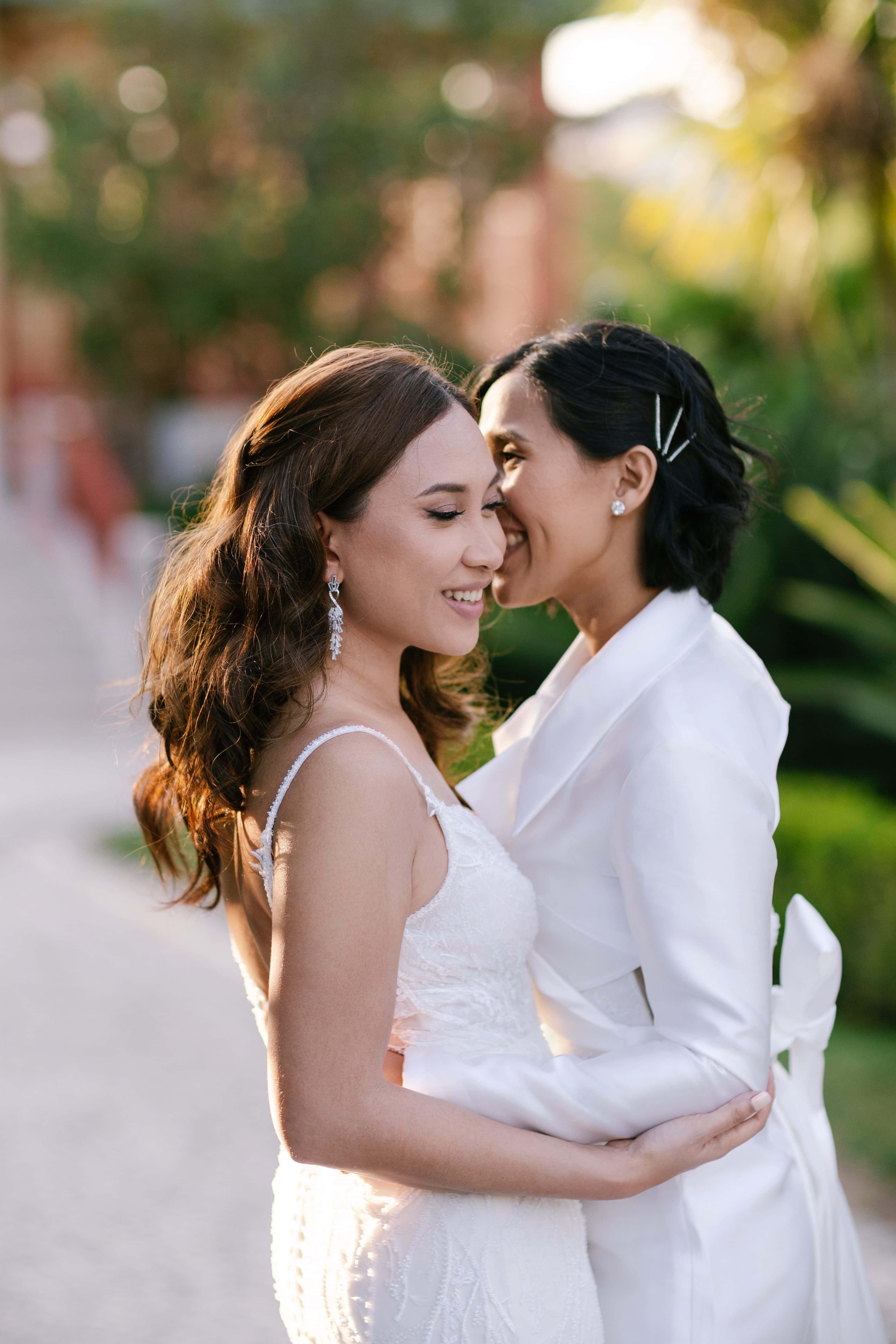 Close portrait of two brides in the gardens of Pestana Palace, Lisbon Close portrait of two brides in the gardens of Pestana Palace, Lisbon