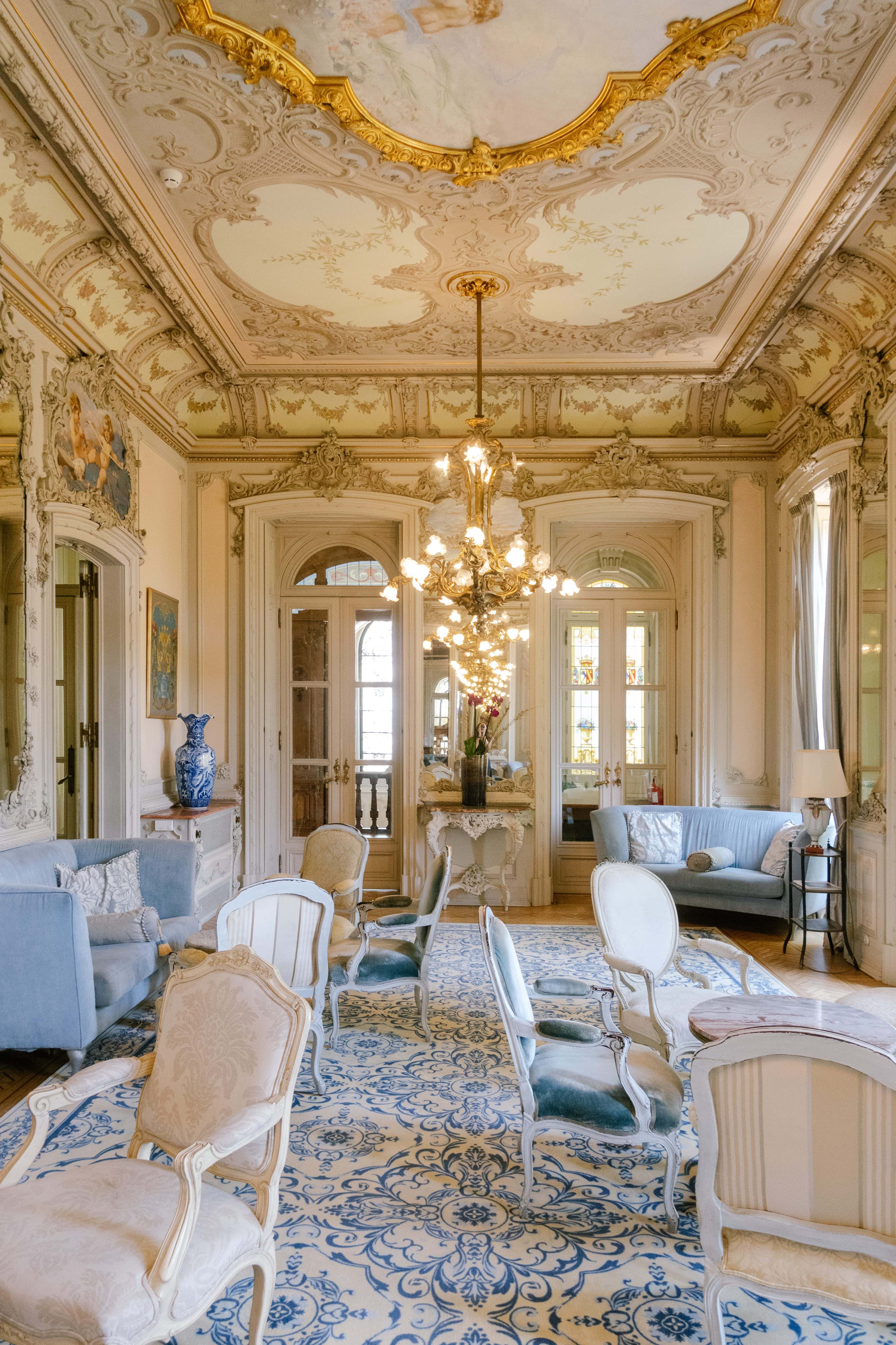 Ornate salon with a painted ceiling and chandelier inside Pestana Palace Lisbon Ornate salon with a painted ceiling and chandelier inside Pestana Palace Lisbon