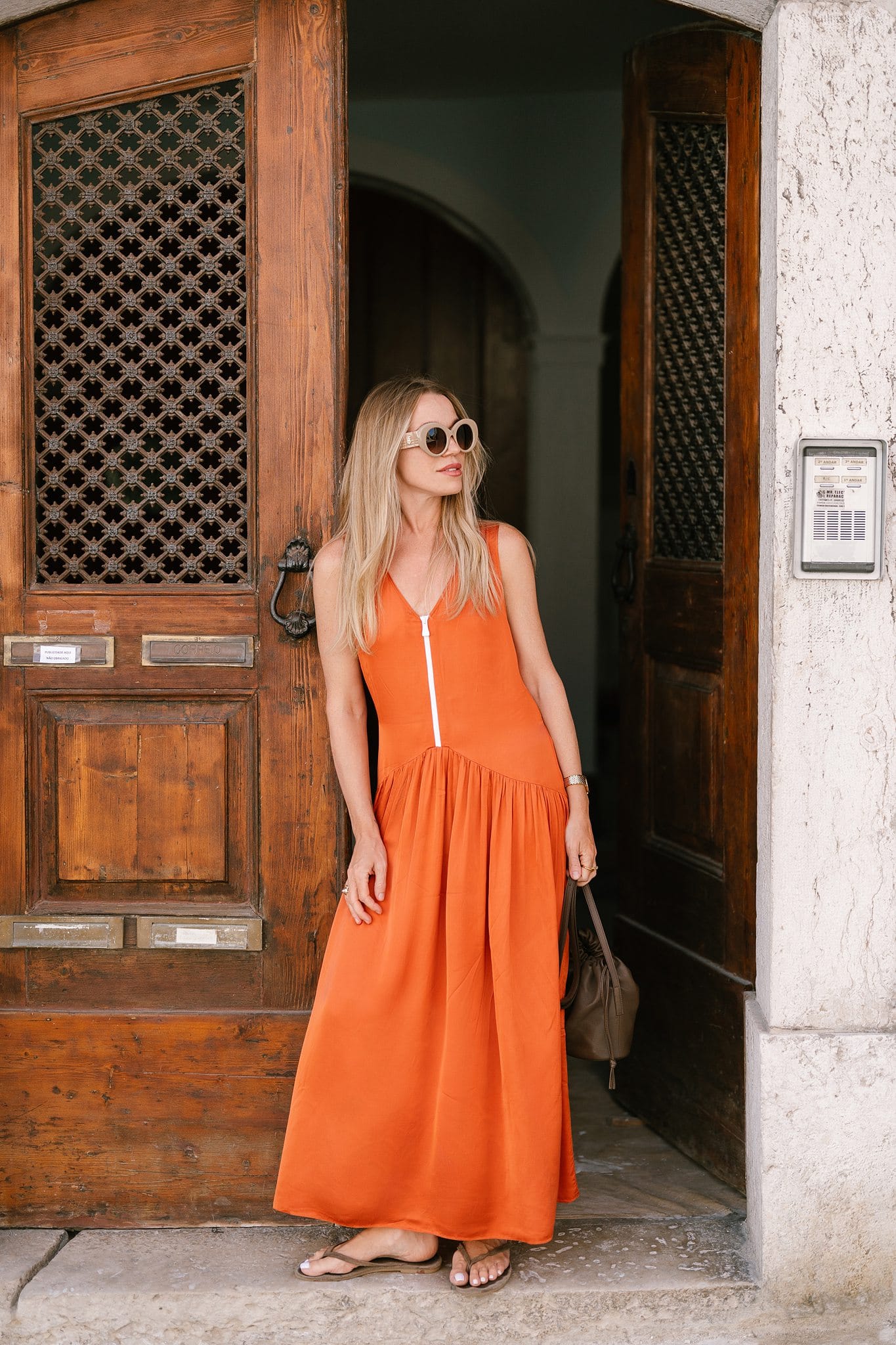 Woman in an orange dress in a Lisbon doorway