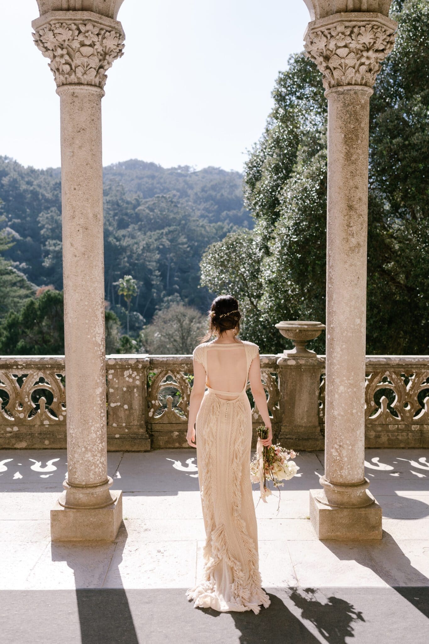 Bride among the carved columns of Monserrate Palace overlooking the gardens, Sintra Bride among the carved columns of Monserrate Palace overlooking the gardens, Sintra