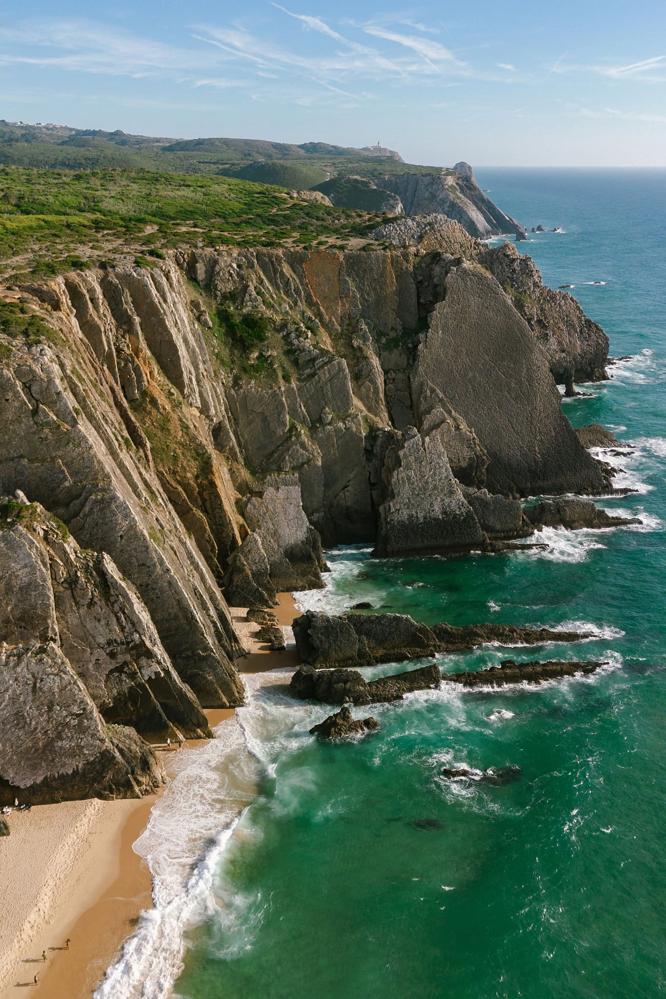 Cliffs above the turquoise water of Praia Grande, Sintra, from above Cliffs above the turquoise water of Praia Grande, Sintra, from above