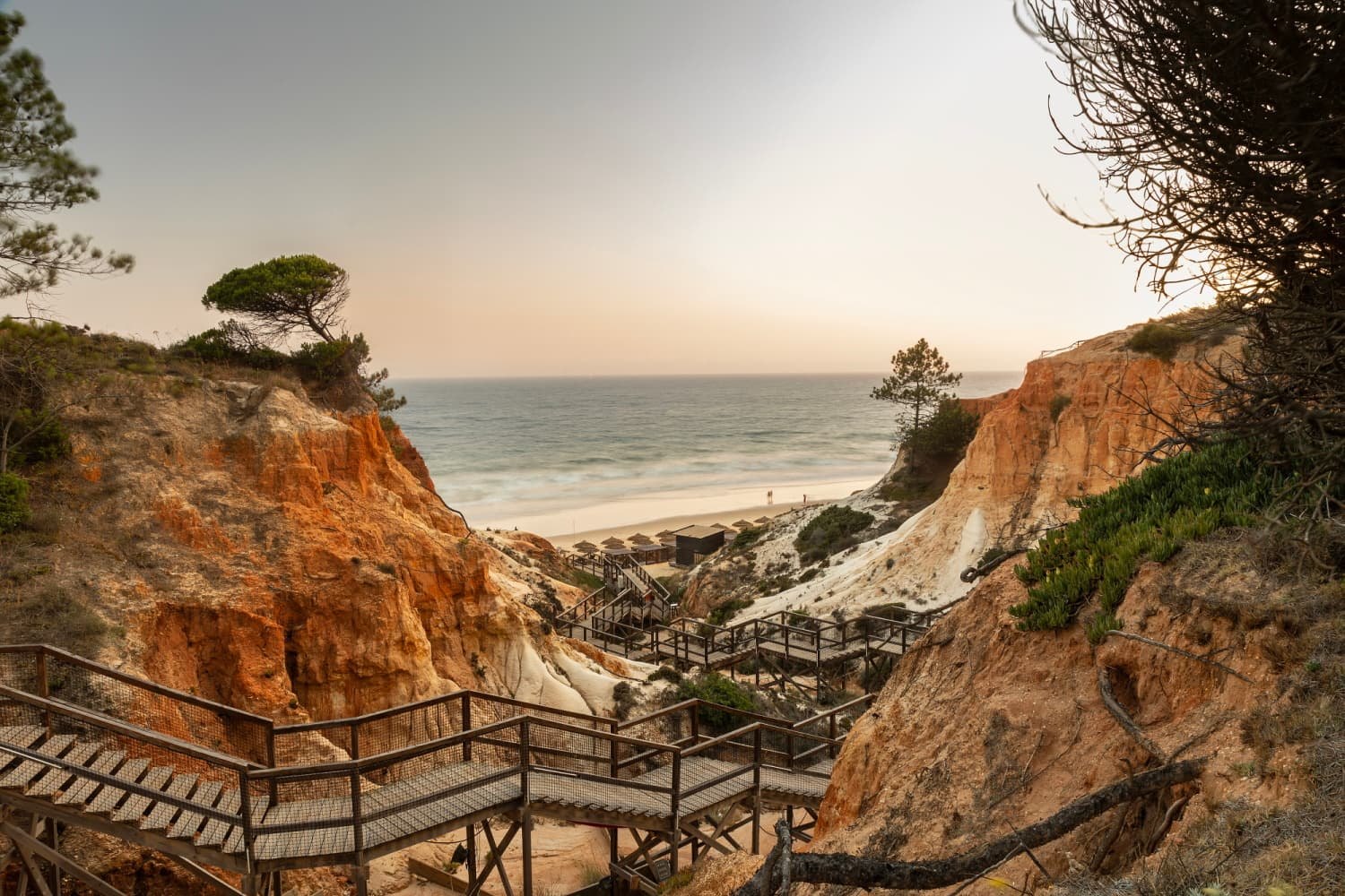 Wooden boardwalk down through the red cliffs to Praia da Falésia at sunset, EPIC SANA Algarve Wooden boardwalk down through the red cliffs to Praia da Falésia at sunset, EPIC SANA Algarve