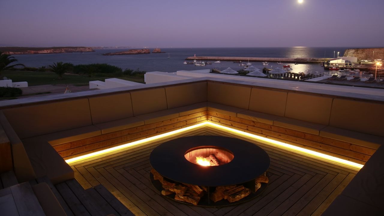 A sunken fire pit lit at dusk above the harbour, Memmo Baleeira, Sagres A sunken fire pit lit at dusk above the harbour, Memmo Baleeira, Sagres