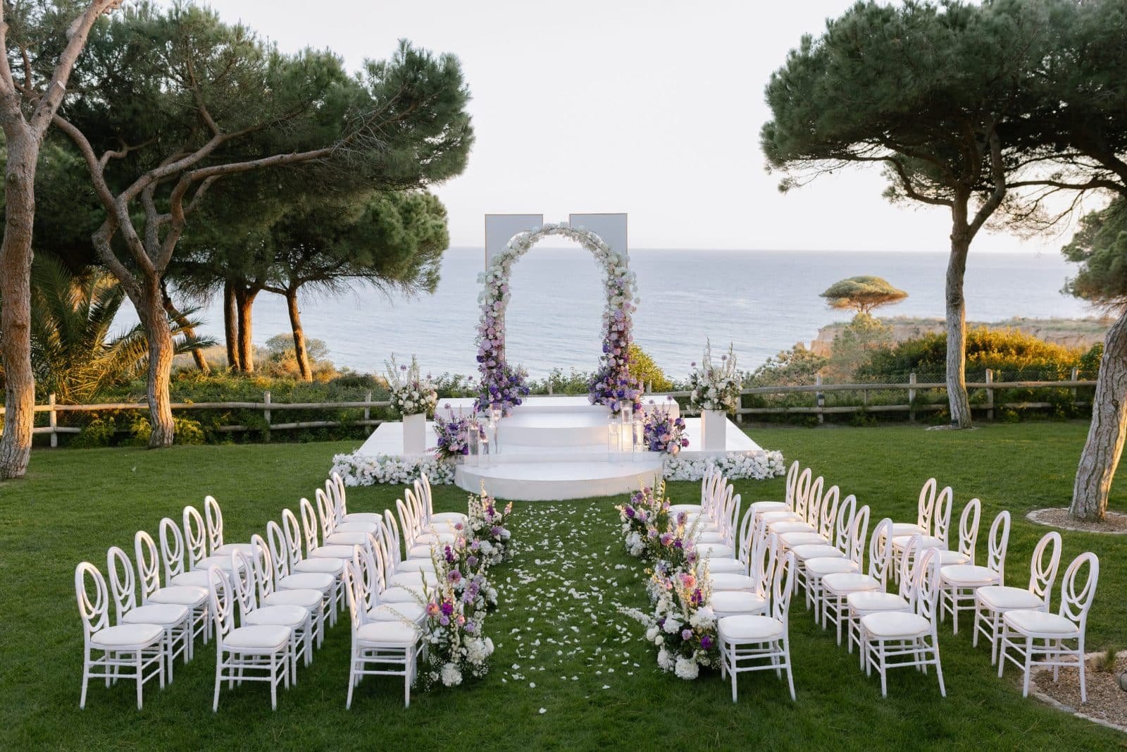Ceremony set on a lawn among the pines above the sea, Pine Cliffs, Albufeira Ceremony set on a lawn among the pines above the sea, Pine Cliffs, Albufeira