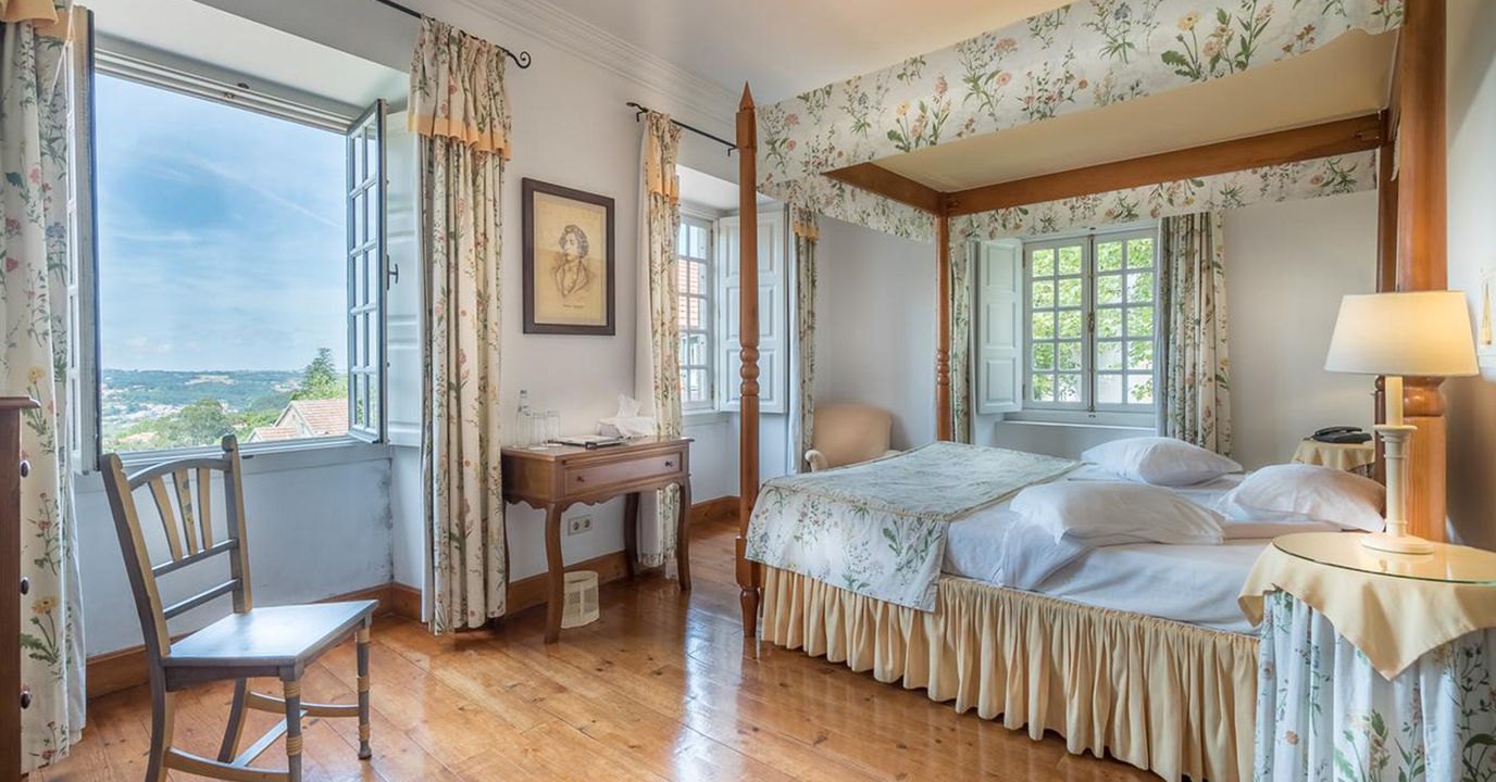 Bedroom with floral curtains and tall windows over the Sintra valley, Lawrence's Hotel Bedroom with floral curtains and tall windows over the Sintra valley, Lawrence's Hotel