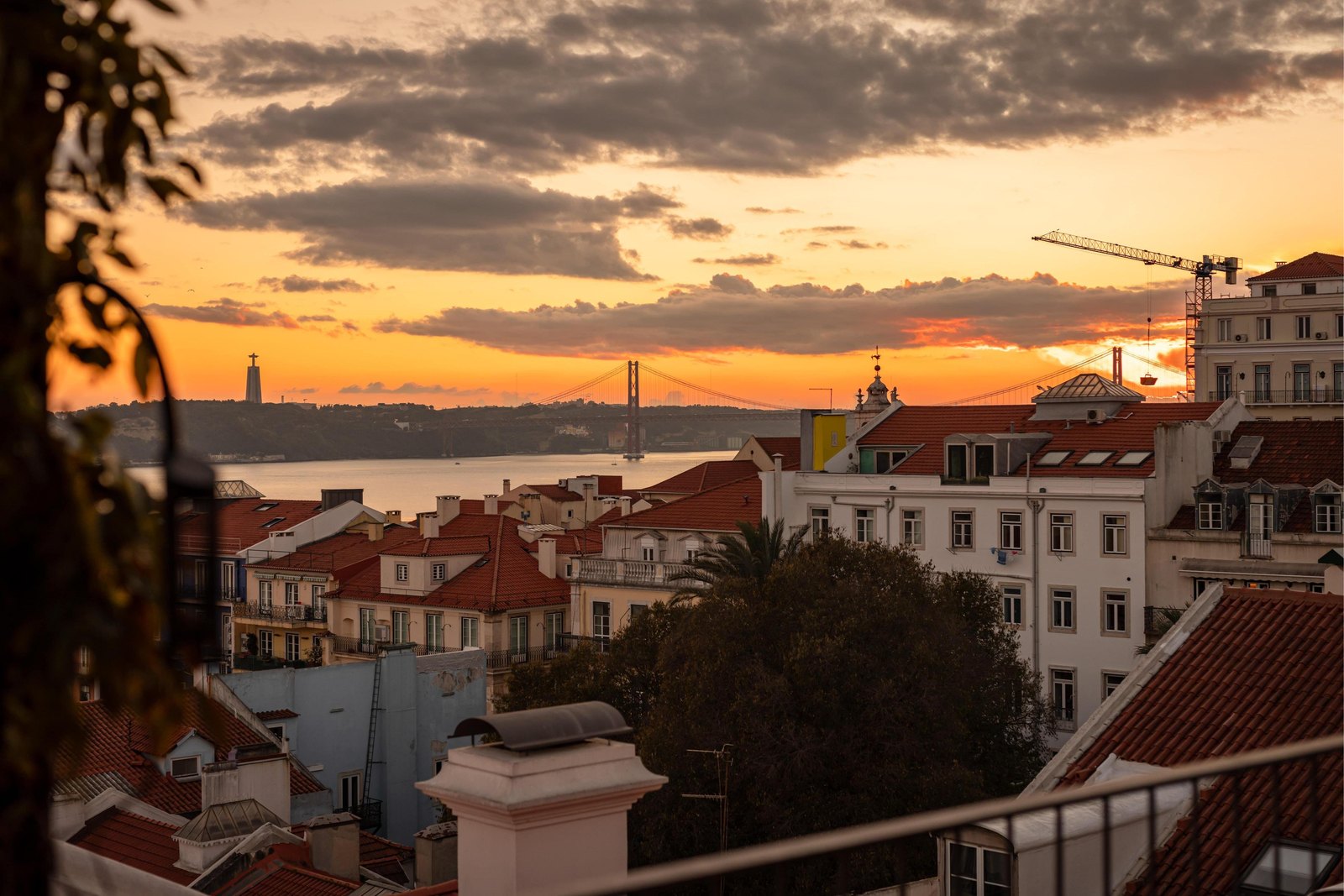 Sunset over the red rooftops and the Tagus from the terrace of the Bairro Alto Hotel, Lisbon Sunset over the red rooftops and the Tagus from the terrace of the Bairro Alto Hotel, Lisbon