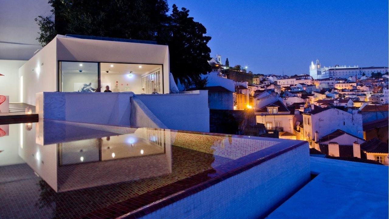 Rooftop infinity pool at blue hour above the lights of Alfama, memmo Alfama, Lisbon Rooftop infinity pool at blue hour above the lights of Alfama, memmo Alfama, Lisbon