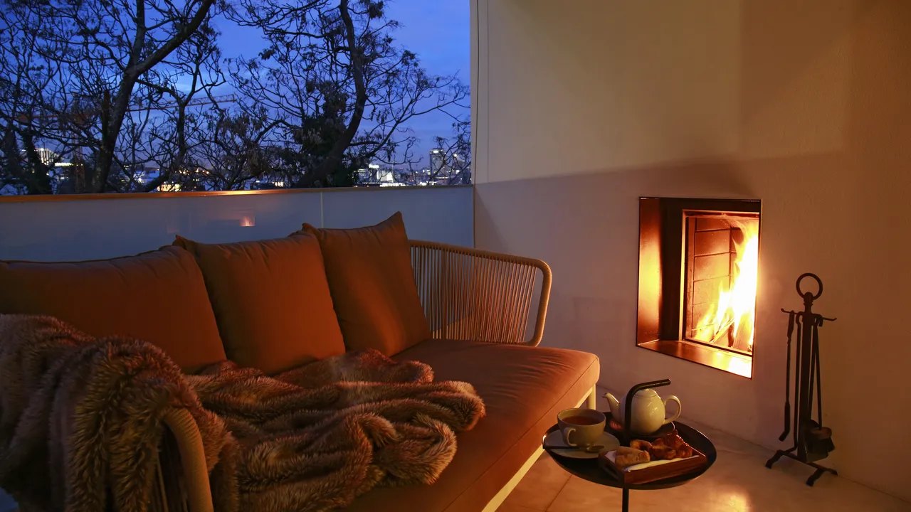 Balcony with an outdoor fireplace and a sofa above the city, memmo Príncipe Real, Lisbon Balcony with an outdoor fireplace and a sofa above the city, memmo Príncipe Real, Lisbon