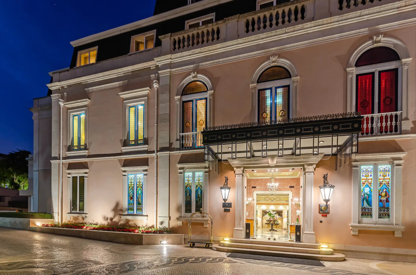 The palace facade and entrance lit up at dusk, Olissippo Lapa Palace, Lisbon The palace facade and entrance lit up at dusk, Olissippo Lapa Palace, Lisbon