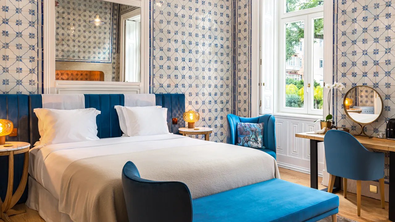 Bedroom with blue-and-white tiled walls, an old fireplace and a velvet bench, Palácio Príncipe Real, Lisbon Bedroom with blue-and-white tiled walls, an old fireplace and a velvet bench, Palácio Príncipe Real, Lisbon