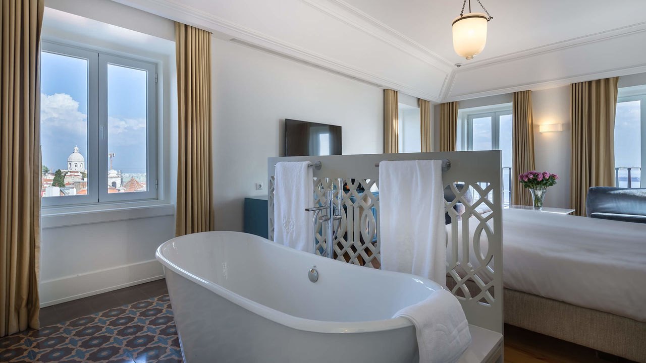 Suite with a freestanding bath beside a window over the rooftops of Alfama, Santiago de Alfama, Lisbon Suite with a freestanding bath beside a window over the rooftops of Alfama, Santiago de Alfama, Lisbon