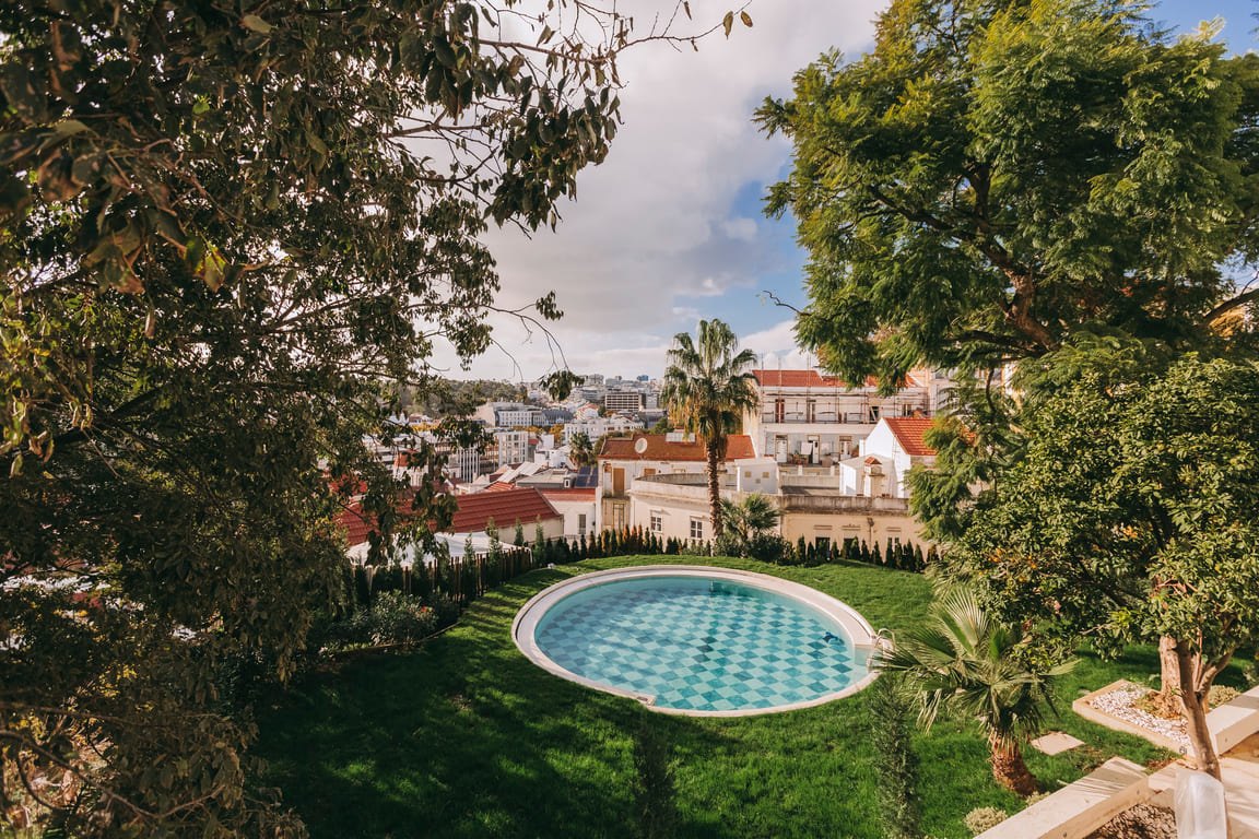 Round garden pool below the palace with Lisbon's rooftops beyond, Torel Palace Round garden pool below the palace with Lisbon's rooftops beyond, Torel Palace