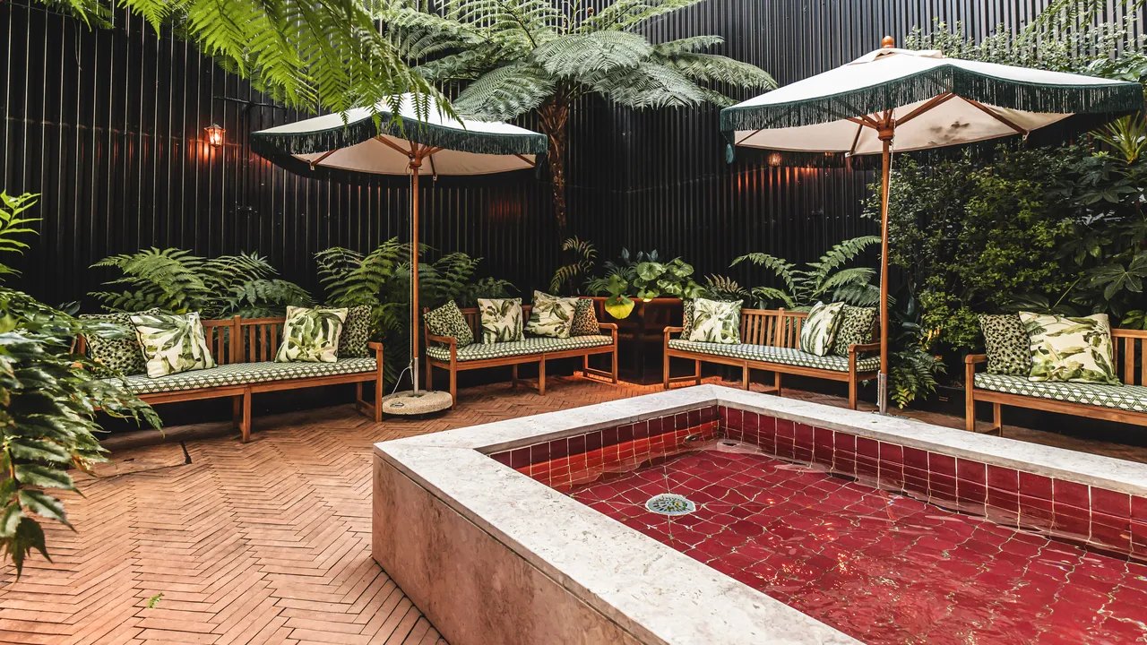Leafy patio garden with parasols, cushioned seats and a red-tiled pool, Valverde Lisboa Leafy patio garden with parasols, cushioned seats and a red-tiled pool, Valverde Lisboa