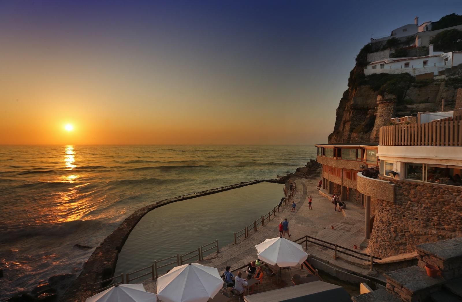 Sunset over the ocean pool below the cliff-top village of Azenhas do Mar, Sintra coast