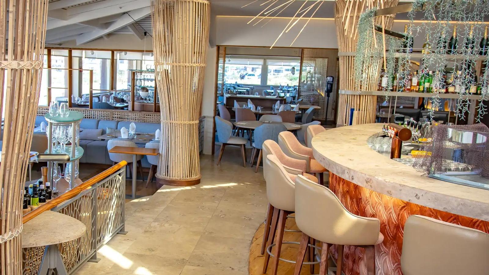 Dining room with bamboo-wrapped pillars and a sea-blue lounge bar looking onto the ocean, Porto Santa Maria, Guincho
