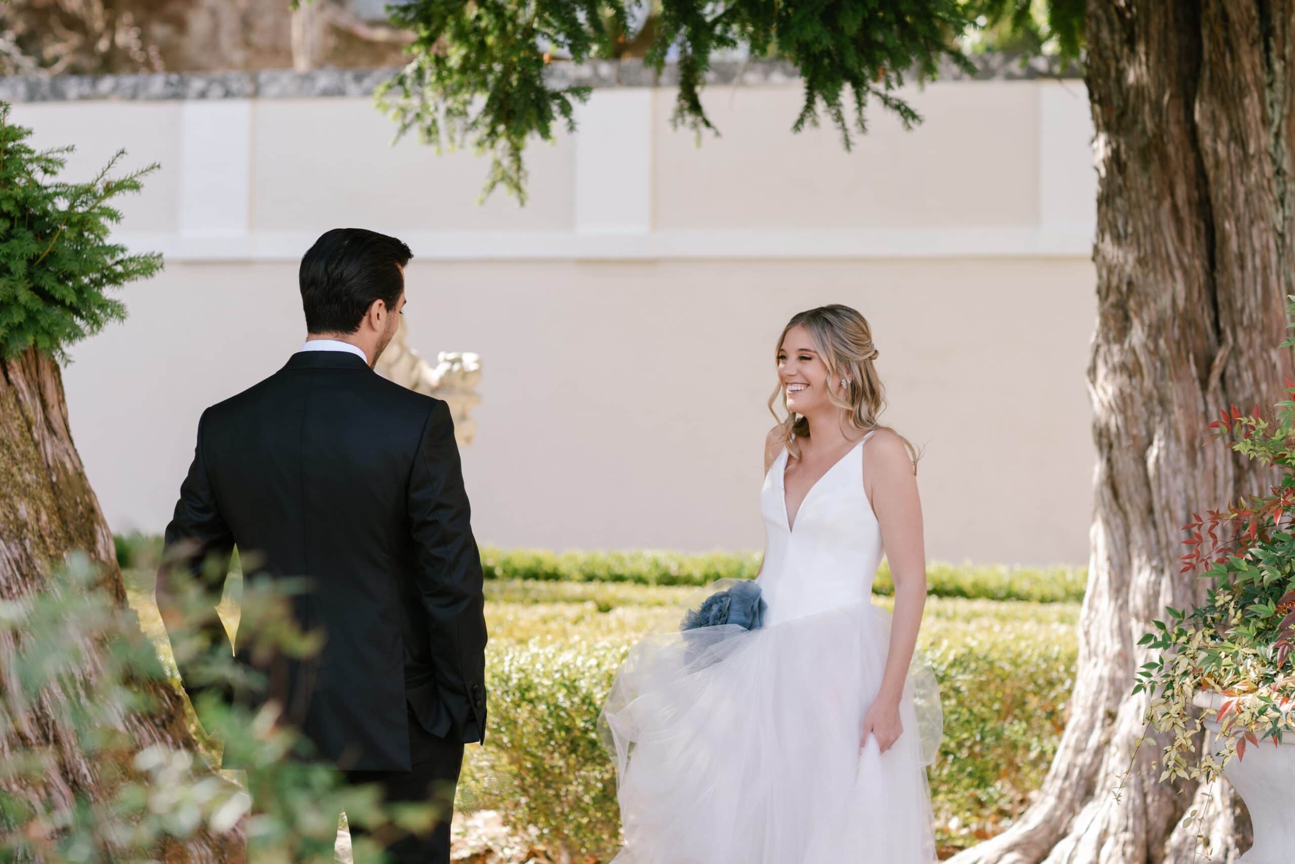 Bride joyfully approaching her groom for their First Look at Palace of Correio-Mor.