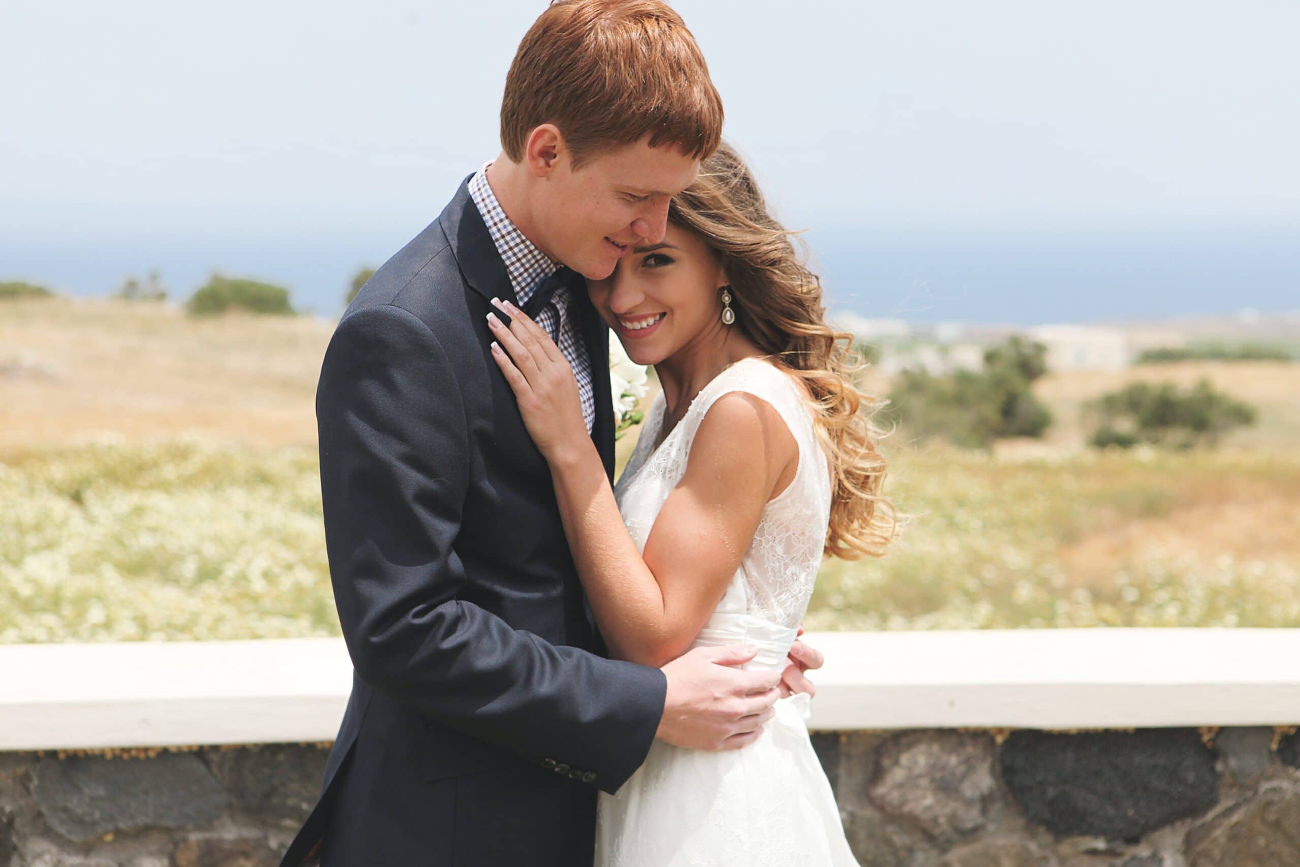 The bride and groom share an intimate embrace on their wedding day, filled with love and joy.