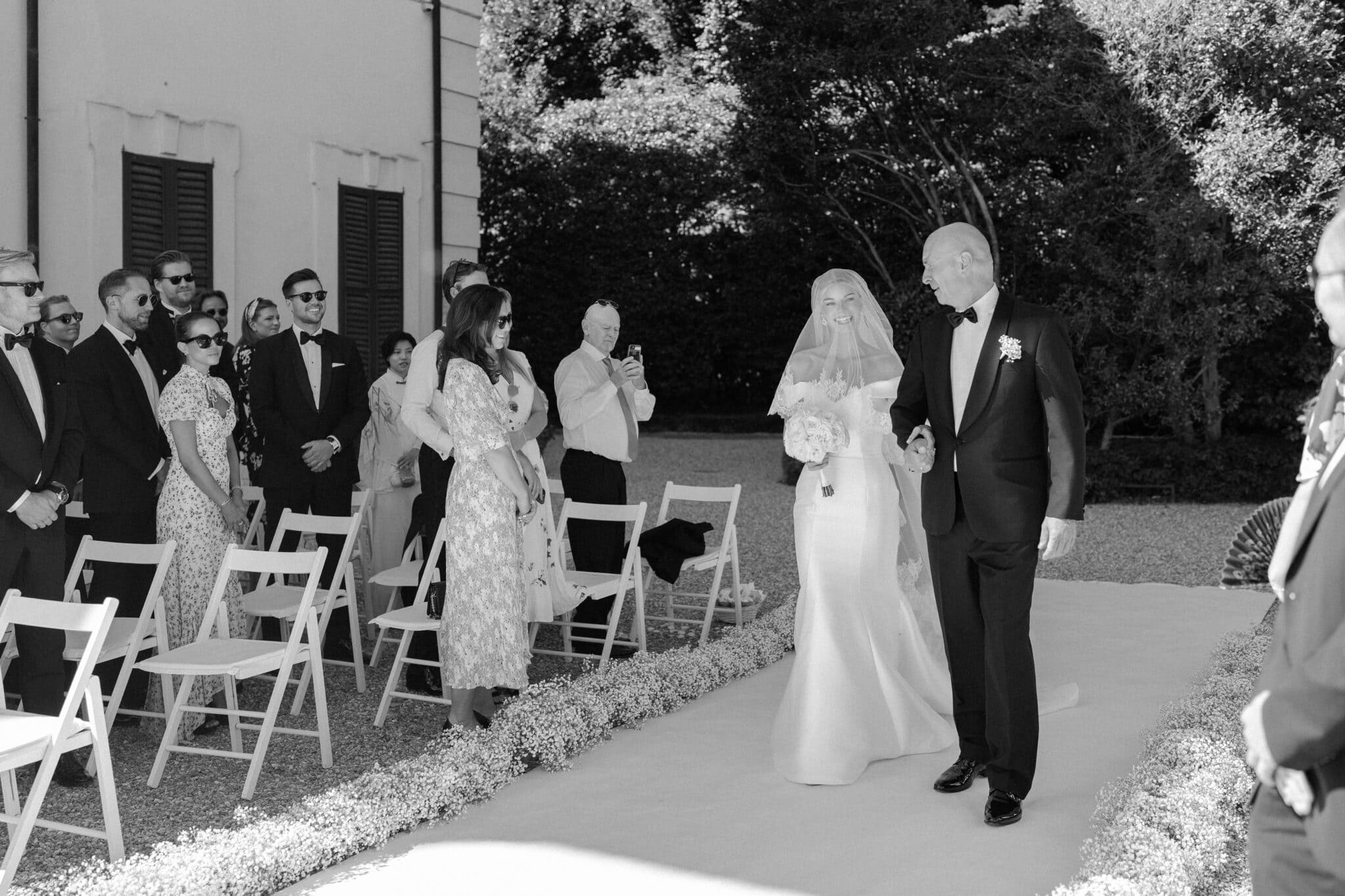 Bride walking down the aisle with her father during a Villa Carlotta wedding ceremony.