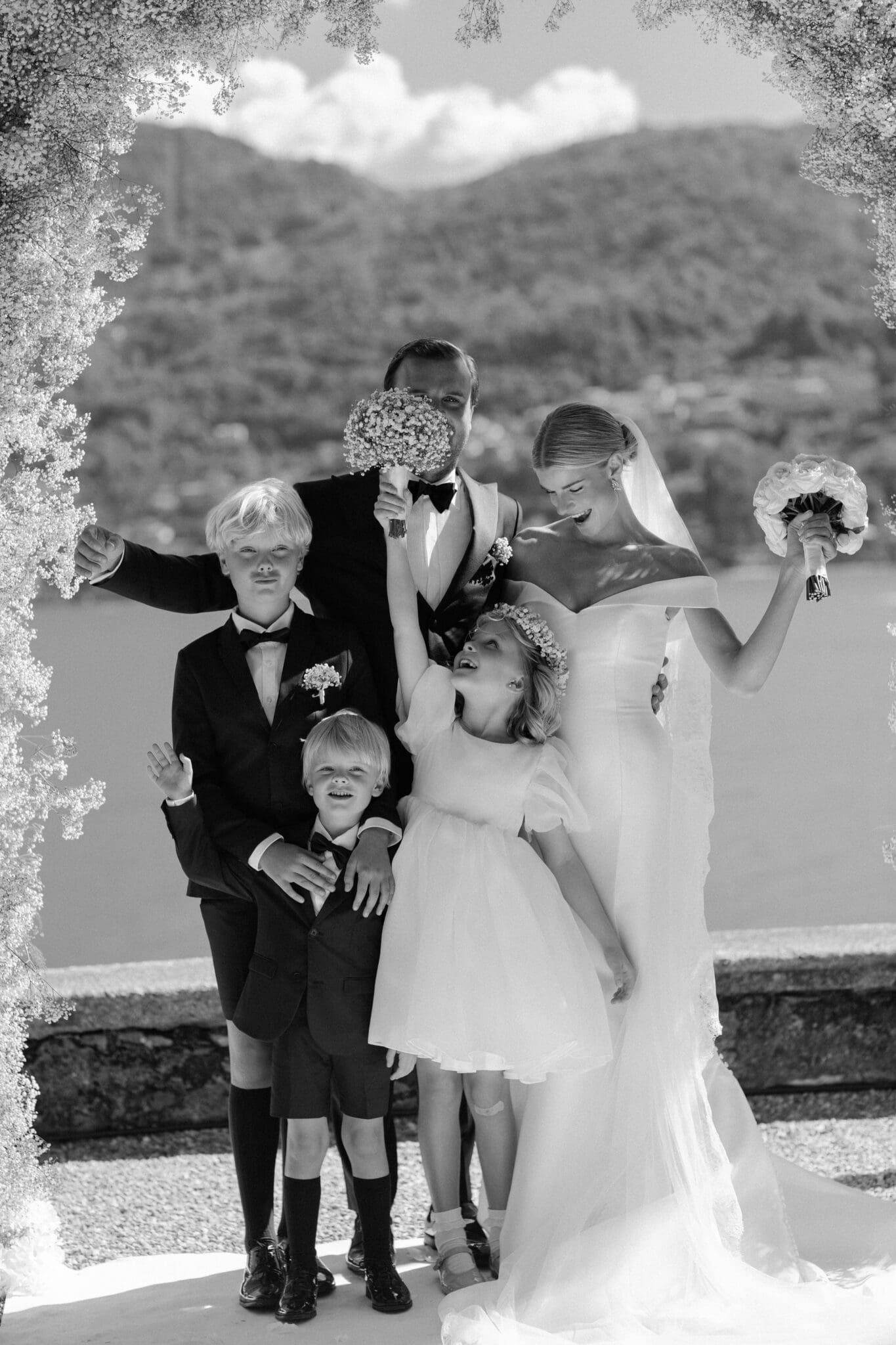 Bride and groom with children joyfully celebrating at Villa Carlotta, Lake Como.