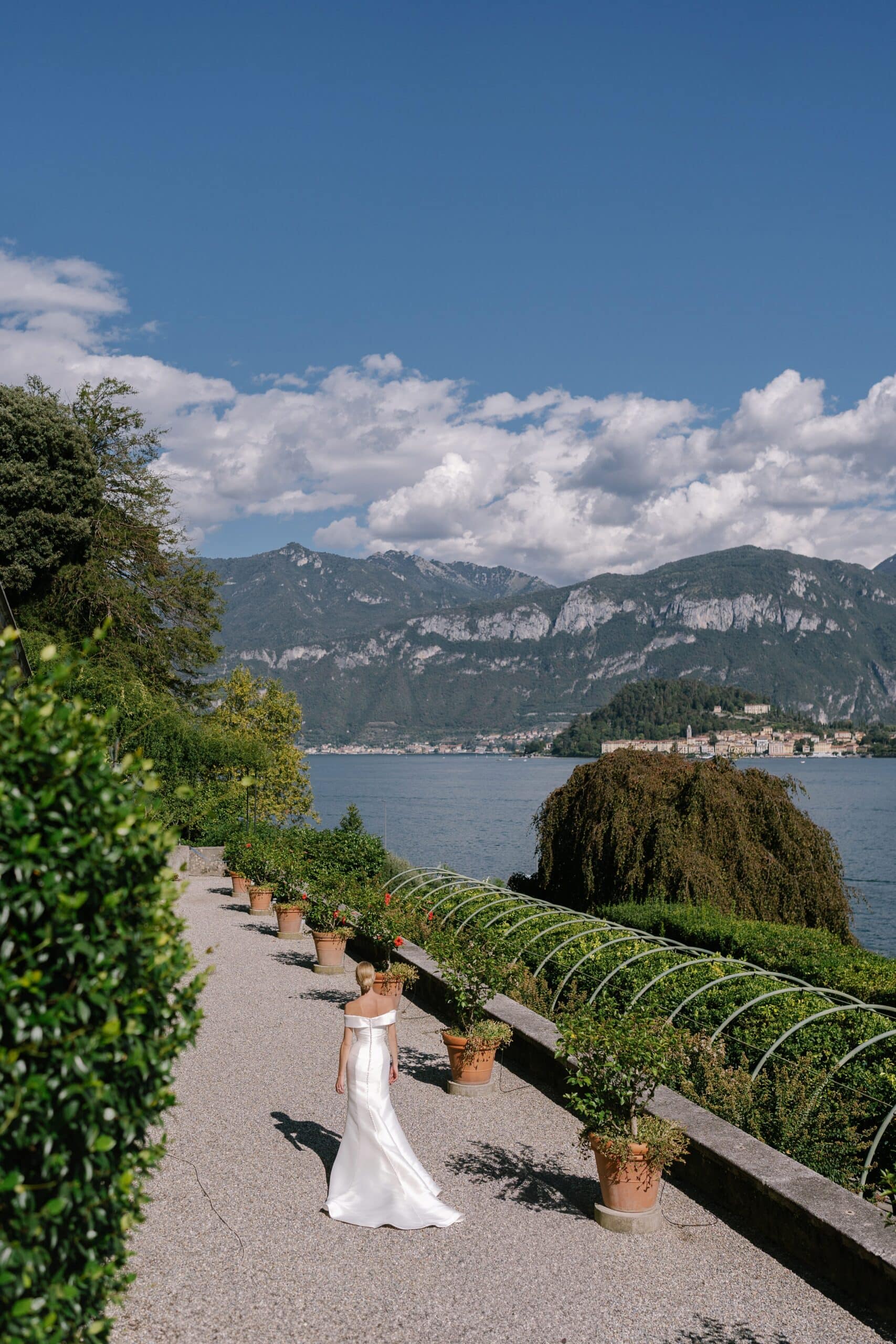 Bride walking along the terrace at Villa Carlotta with panoramic views of Lake Como.