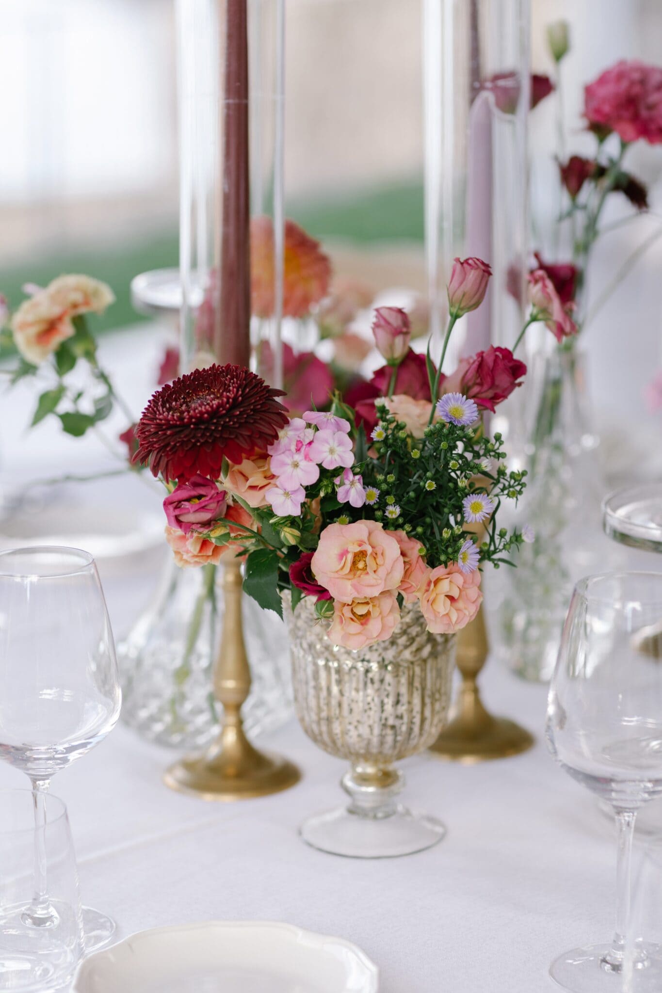 Vibrant floral centerpiece with roses and dahlias at Villa Carlotta wedding reception.