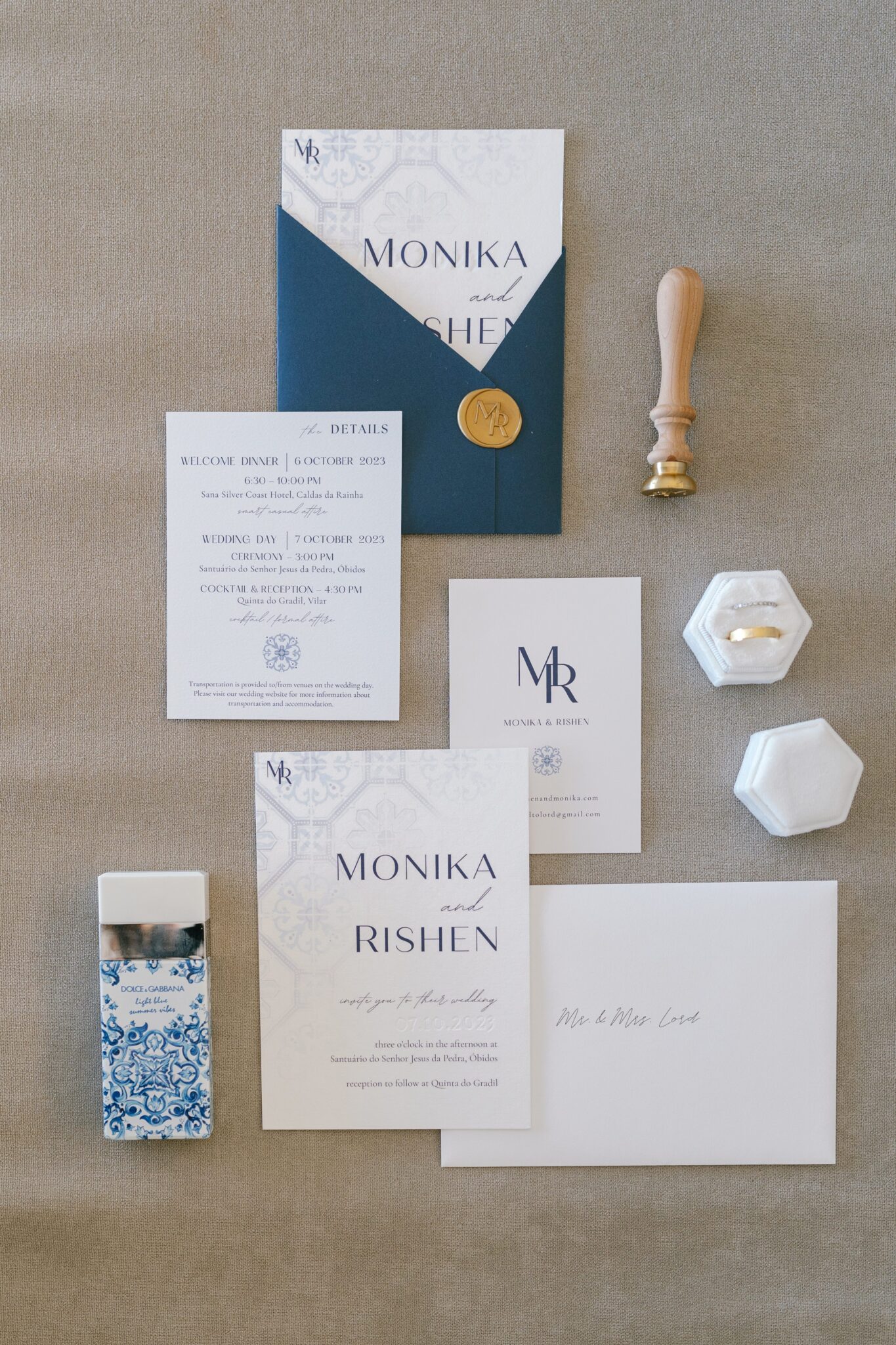 Flatlay of elegant blue and white wedding stationery with wax seal for Portugal destination wedding