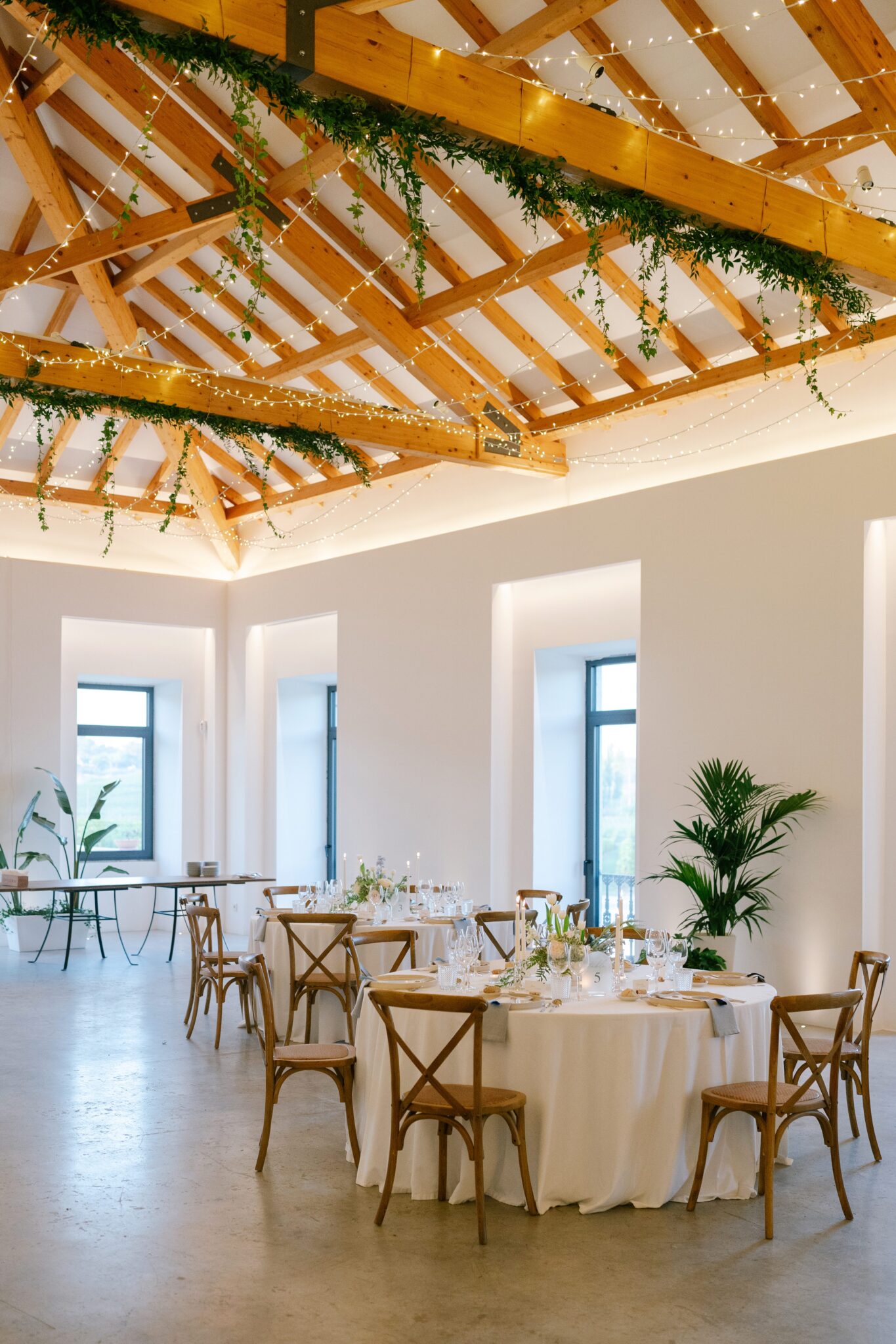 Reception hall at Quinta do Gradil decorated with greenery and fairy lights