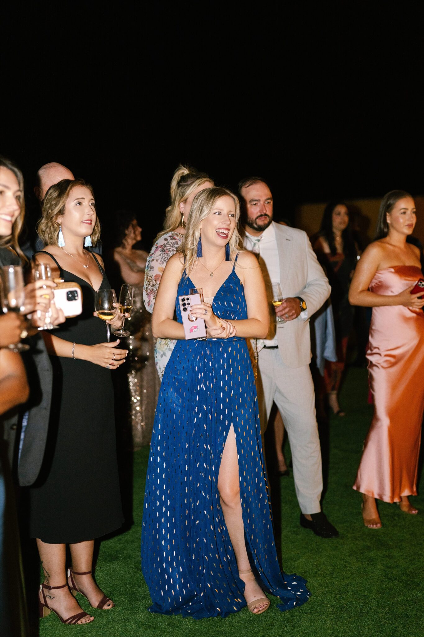 Wedding guests watching evening entertainment bride’s friends enjoying Portugal reception