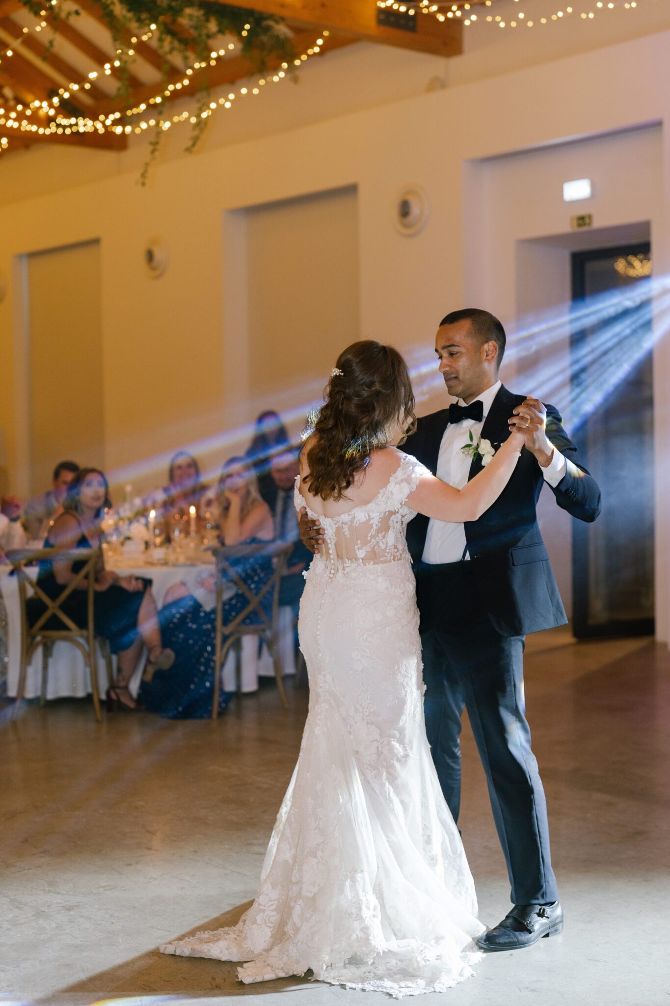 Bride and groom first dance under spotlights at Quinta do Gradil Portugal wedding reception
