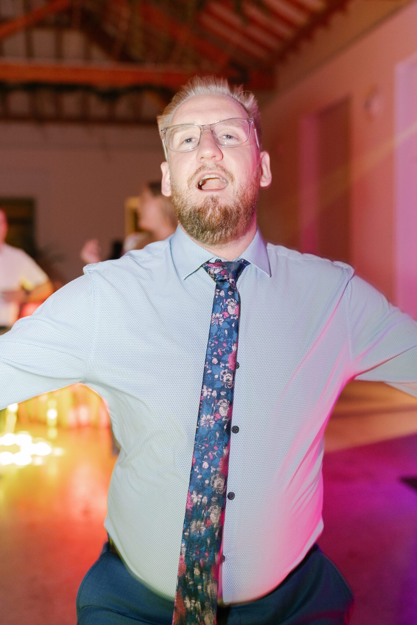 Wedding guest dancing during evening celebration at Portugal destination wedding